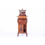 A late 19th century Aesthetic Movement Japonesque carved walnut side cabinet, the top with pierced