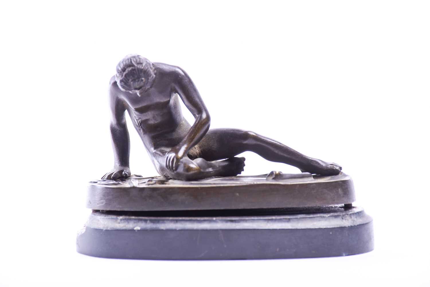 A small bronze figure 'The Dying Gaul', 19th century, on a polished black slate oval base, the