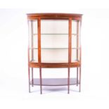 A late 19th century mahognay bow-front display cabinet, with two shelves, lined interior and