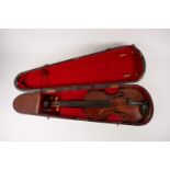 An 18th century full size violin, with two piece back, indistinctly inscribed in ink to the interior