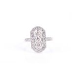 A platinum and diamond ring, the lozenge-shaped mount centred with a row of three round brilliant-