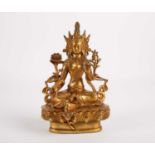 A Tibetan gilt bronze figure of Tara, seated flanked by flowers and ribbons, on a lotus leaf base,