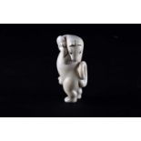 A Japanese carved ivory okimono of a dancing kitsune, late 19th century, the stylised figure with