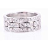 A diamond eternity ring, the white metal mount formed of bar-shaped segments inset with round