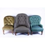 Three button-back easy chairs, all with turned legs and upholstered in differing fabrics.