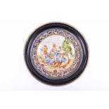 A 19th century Italian maiolica charger in gilt and ebonised frame, the well decorated with battling