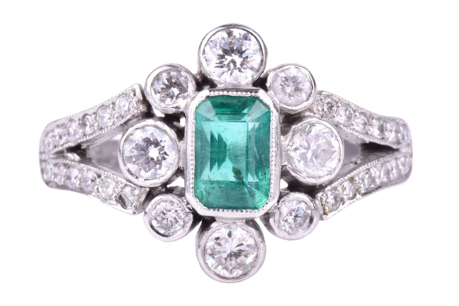 A platinum, diamond, and emerald ringcentred with an emerald-cut emerald of approximately 0.70