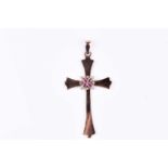 A yellow metal cross pendant, inset with a quatrefoil design of rubies and diamond accents to