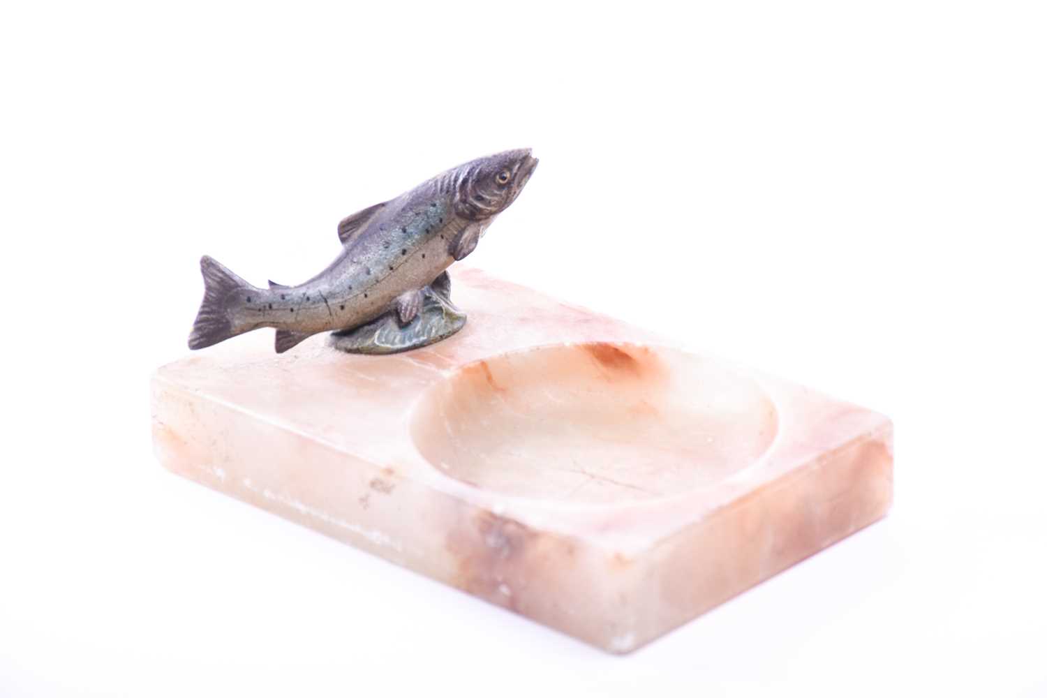 A marble trinket dish surmounted with a small cold painted bronze leaping Salmon, early 20th