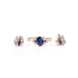 A 9ct yellow gold, diamond, and sapphire ring, set with a mixed oval-cut sapphire flanked with six