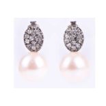 A pair of silver, cubic zirconia, and pearl drop earrings, the oval mount pave-set with round-cut