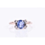 A diamond and sapphire ring, set with a blue sapphire of approximately 1.20 carats, four-claw set,