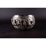 An Indian silver bowl, typically relief decorated with figures and animals, above a band of