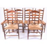 A set of six early 20th century ladderback and rush seated dining chairs, including two carvers,