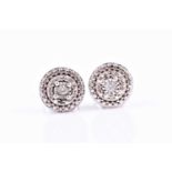 A pair of white metal and diamond cluster ear studs,7 mm diameter, illusion set with round