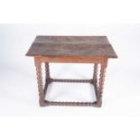 A late 17th / early 18th century oak low boy, the two plank top with moulded rim, and supported on
