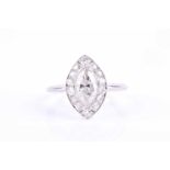 A platinum and diamond cluster ring, set with a marquise-cut diamond of approximately 1.0 carats,