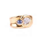 An 18ct yellow gold, diamond, and sapphire band ring, with stylised tear-drop motif pave-set with