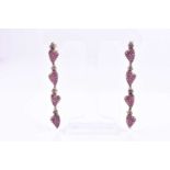A pair of silver gilt, diamond, and ruby drop pendant earringsthe articulated mounts of four heart-