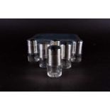 A cased set of six silver and glass peppers of cylindrical form, London 1928 by Harman & Co, each