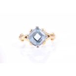 An 18ct yellow gold and aquamarine ring, set with a mixed cushion-cut aquamarine, four claw set,