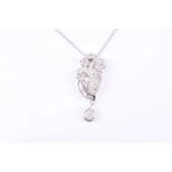 An 18ct white gold and diamond pendant necklace, the asymmetric pendant of swept design, inset