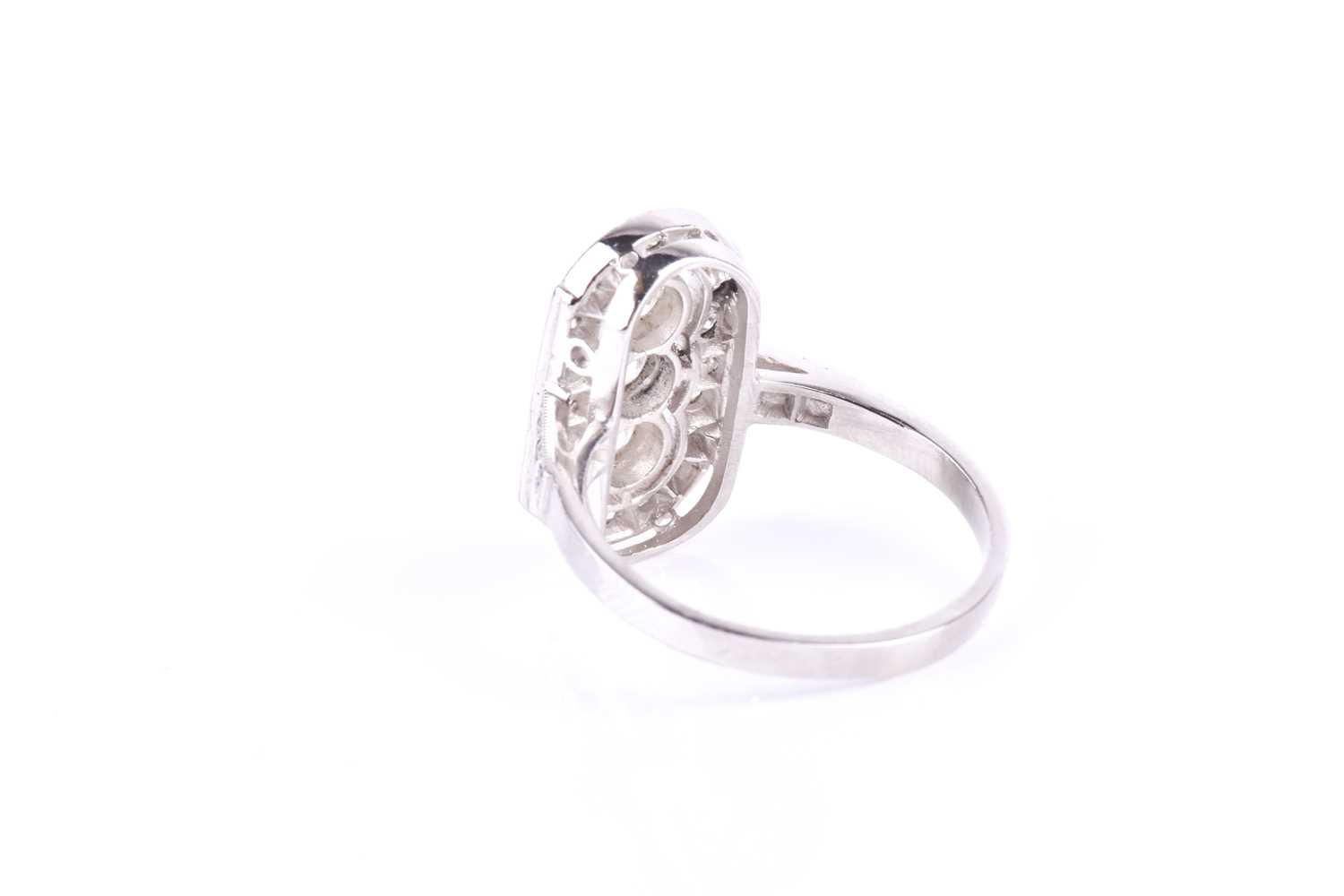 A platinum and diamond ring, the lozenge-shaped mount centred with a row of three round brilliant- - Image 3 of 3