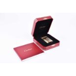 Cartier. A silver gilt lighter, the case with finely ribbed decoration, numbered 433380