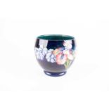 A Walter Moorcroft Orchid pattern jardiniere, on a shaded blue ground, blue inscribed initials,
