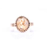 A 9ct yellow gold and citrine ring, set with a mixed oval-cut citrine, multi-claw setting with