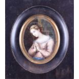 A 19th century portrait miniature on ivory, depicting a woman at prayer, a halo above her, unsigned,