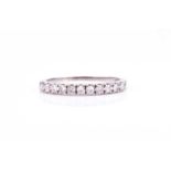 An 18ct white gold and diamond half eternity ring, set with eleven eight-cut diamonds, each