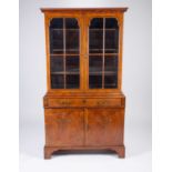 An 18th century walnut and oyster wood secretaire bookcase, the top with a pair of astragal glazed
