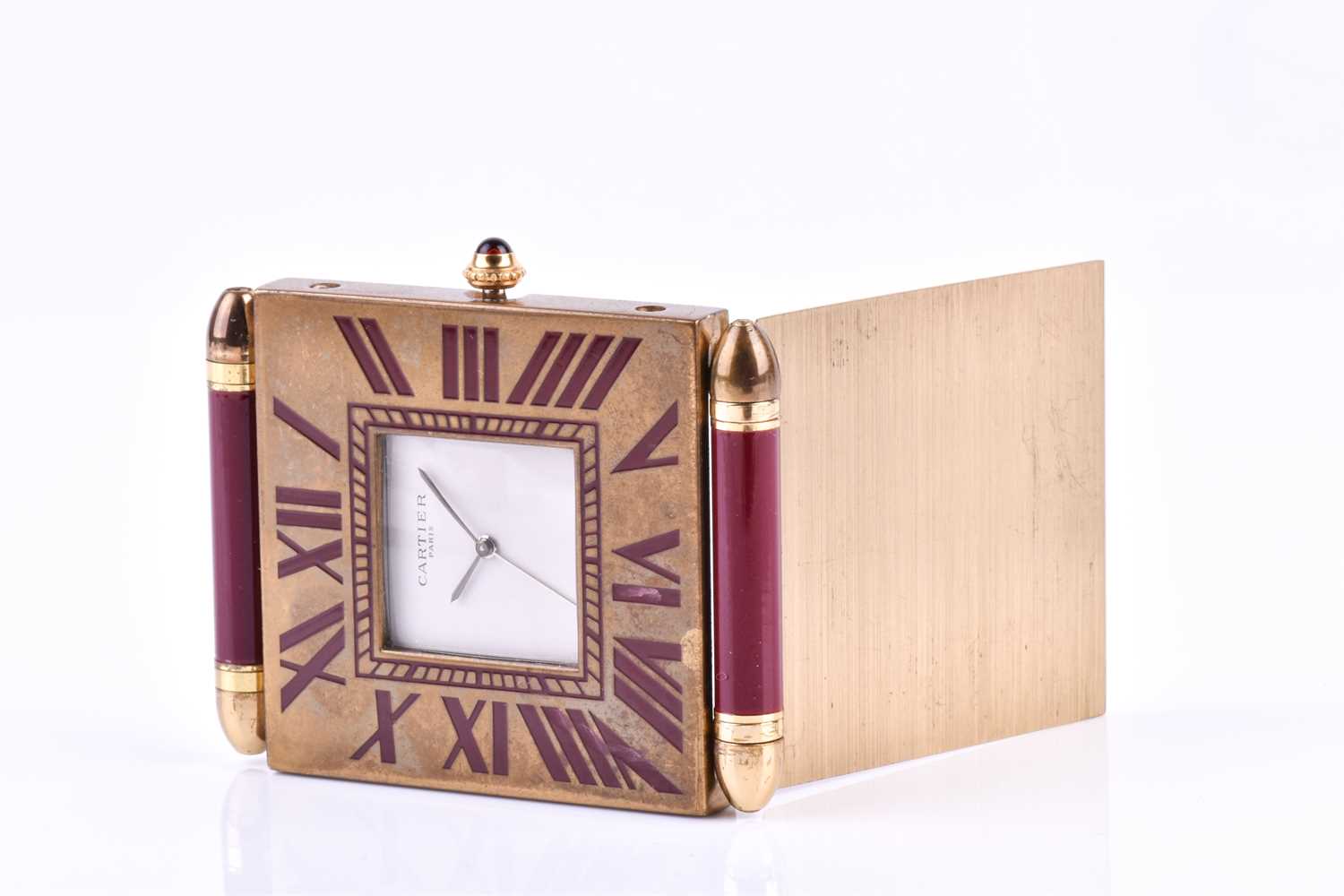 A Cartier travel clock, of square form with gilt metal case with claret lacquered Roman numerals, - Image 4 of 13