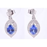 A pair of diamond and tanzanite drop earrings, the white metal lozenge-shaped mounts centred with