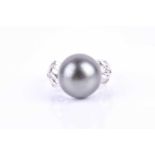 An 18ct white gold, diamond, and dark grey Tahitian pearl ring, the pearl approximately 14 mm