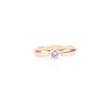 A yellow metal and solitaire diamond ring, set with a round brilliant-cut diamond of approximately