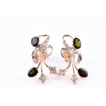 A pair of yellow metal, diamond, and green tourmaline earrings, of stylised cluster design, each set