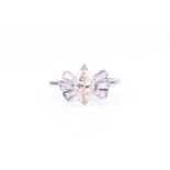 An unusual white metal and diamond ringset with a marquise-cut light brownish yellow diamond of