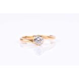 An 18ct yellow gold and solitaire diamond ring, the crossover style mount set with a round