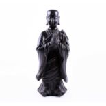 A Chinese bronze Buddhist Monk, Qing, standing in long robes, his palms pressed together in