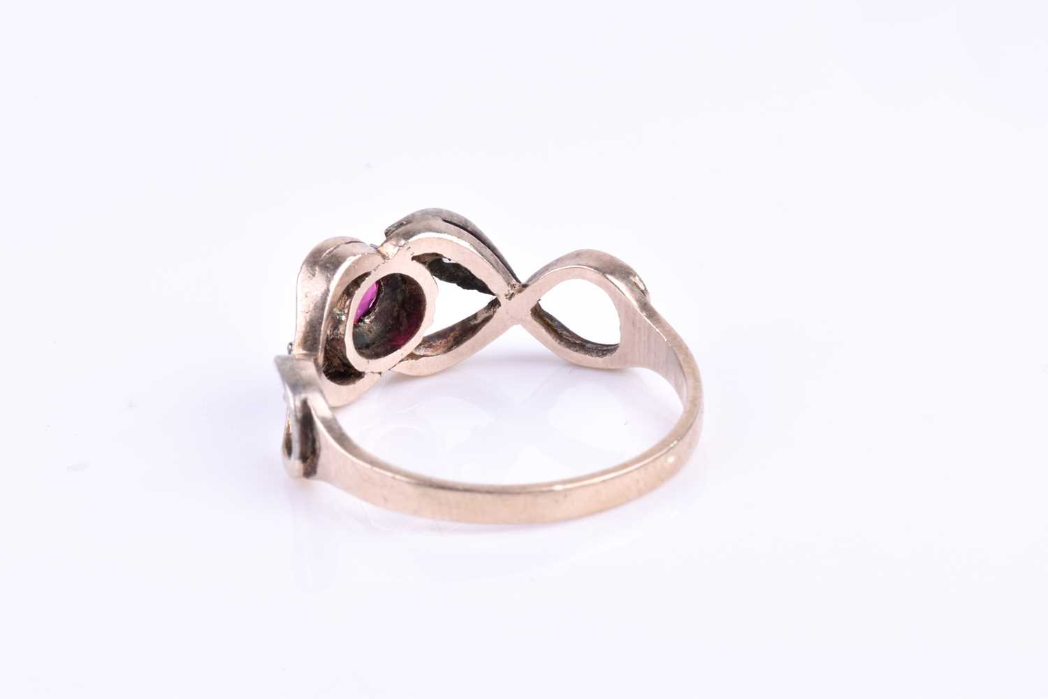 A yellow metal, silver, diamond, and ruby ring, centred with a mixed round-cut ruby in a yellow gold - Image 3 of 3