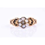 A late 19th / early 20th century yellow gold, pearl, and black enamel daisy cluster ring, centred
