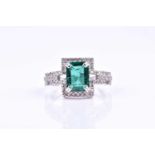 An emerald and diamond cocktail ring, set with a mixed rectangular-cut emerald, with a stylised