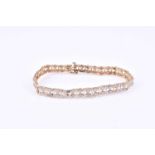 A 9ct yellow gold and diamond bracelet, the white gold mounts inset with small round-cut diamonds,