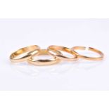 A 22ct yellow gold wedding band (a/f, break to band), size q, together with three yellow metal