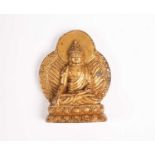 A Tibetan gilt bronze figure of Buddha Shakyamuni, seated before a gilt nimbus, on double lotus