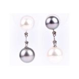 A pair of white and grey South Sea and Tahiti pearl drop earrings, one with a smaller grey pearl