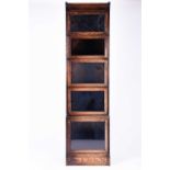 An early 20th century narrow stacking bookcase, in five sections with side opening glazed doors, 172