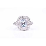 A platinum, diamond, and aquamarine ring, set with a rectangular cushion-cut aquamarine of